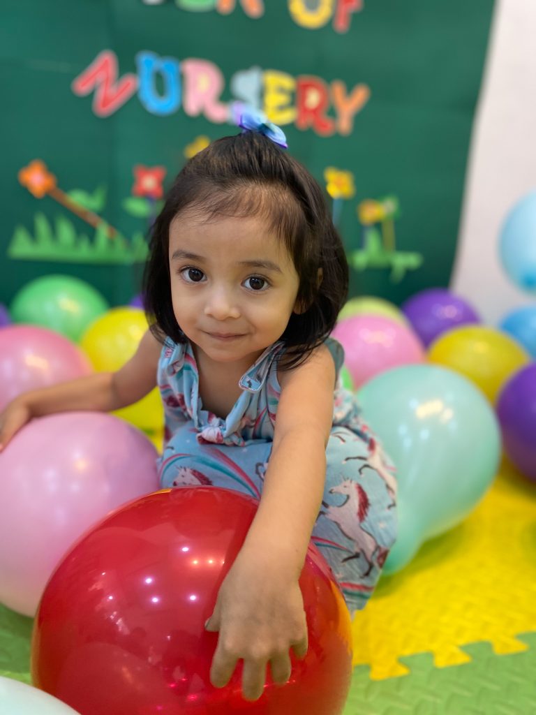 girl playing with balloons